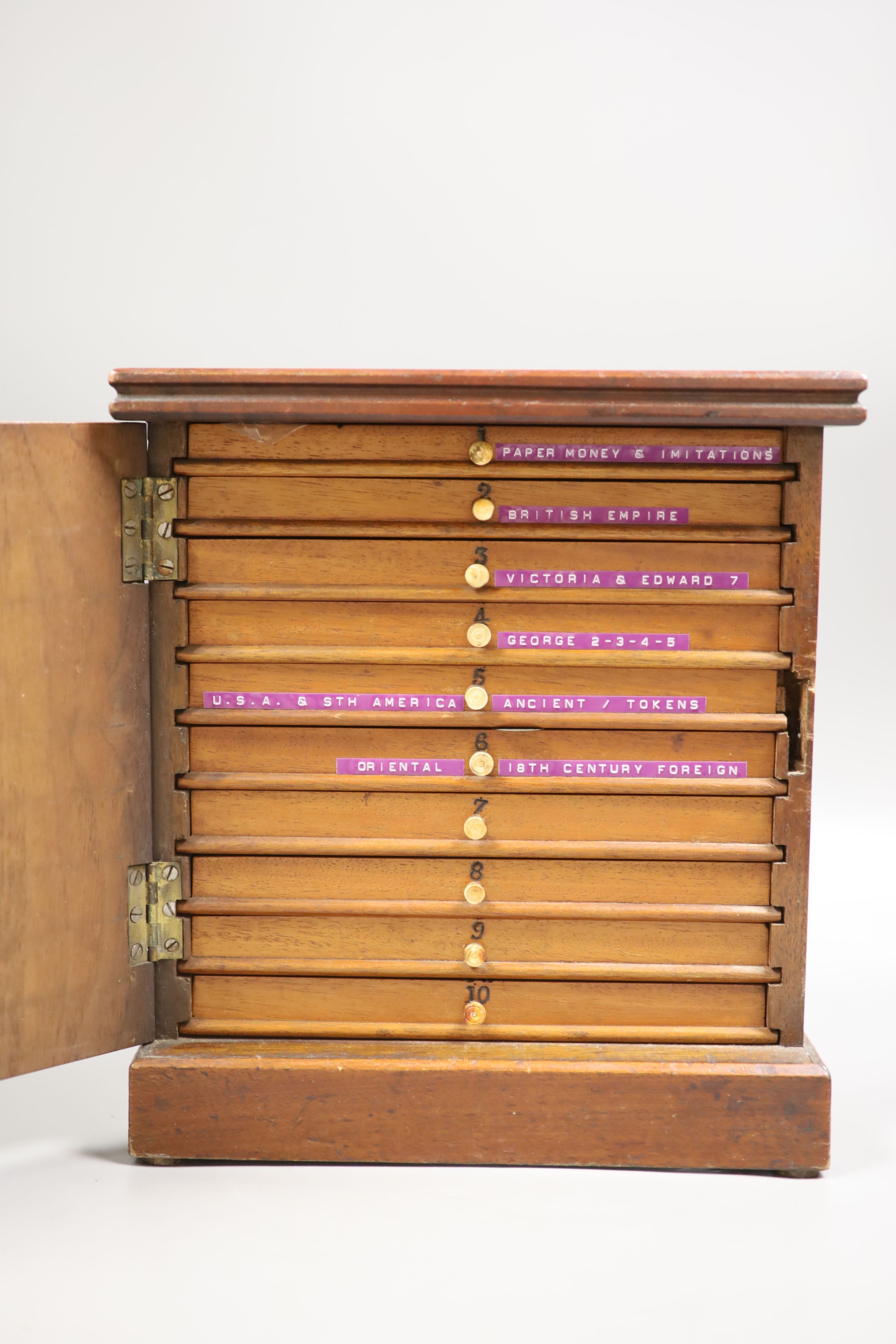 A mahogany coin collector's cabinet, fitted single door enclosing 10 drawers containing British and other coins (Georgian and later), tokens, etc.